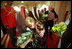 Two children greet Vice Present Dick Cheney and Mrs. Cheney with bouquets of flowers upon their arrival at Dasman Palace in Kuwait City, Kuwait, March 18.